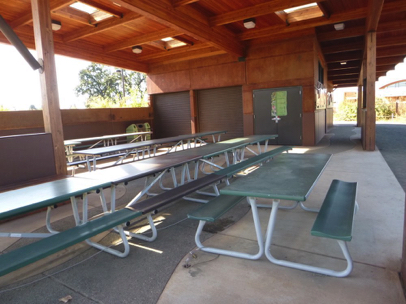 Nature Explorers Shelter located off restroom - picnic tables on concrete - garbage and recycling bins